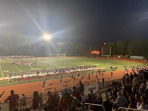 The classic American high school football game is a staple social event in schools across the country. Here, in a photo of our very own team, we can see the large crowd and excitement surrounding the tradition. 
