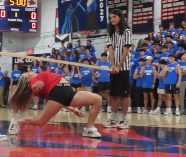 Elena Lemery gets as low as she can for the Limbo contest.